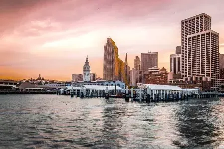 O Ferry Building ao pôr do sol visto da baía.